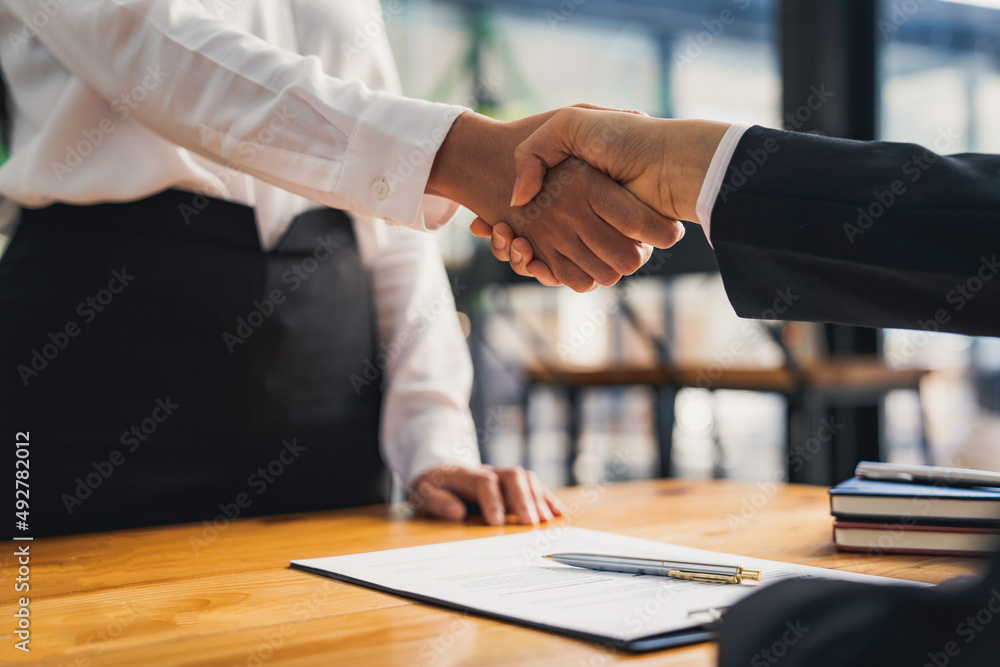 business people Or head of personnel shaking hands congratulating new employees in an interview after a concept office meeting. business people Or head of personnel shaking hands congratulating new employees in an interview after a concept office meeting.