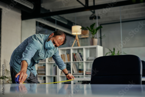 Businessman taking care about protective measures at work during pandemic