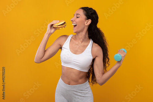 Photos Funny Hungry Lady Holding Burger And Dumbbell