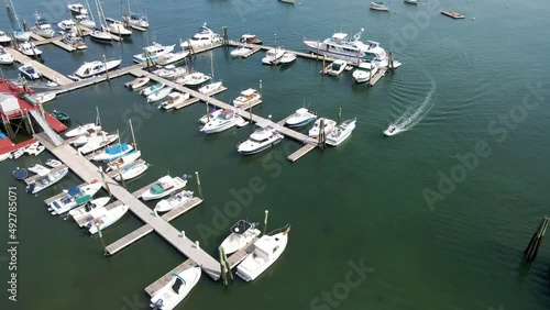 Boats Docked at Rockland Harbor in Maine (USA) | Aerial View Panning Up | Summer 2021 photo