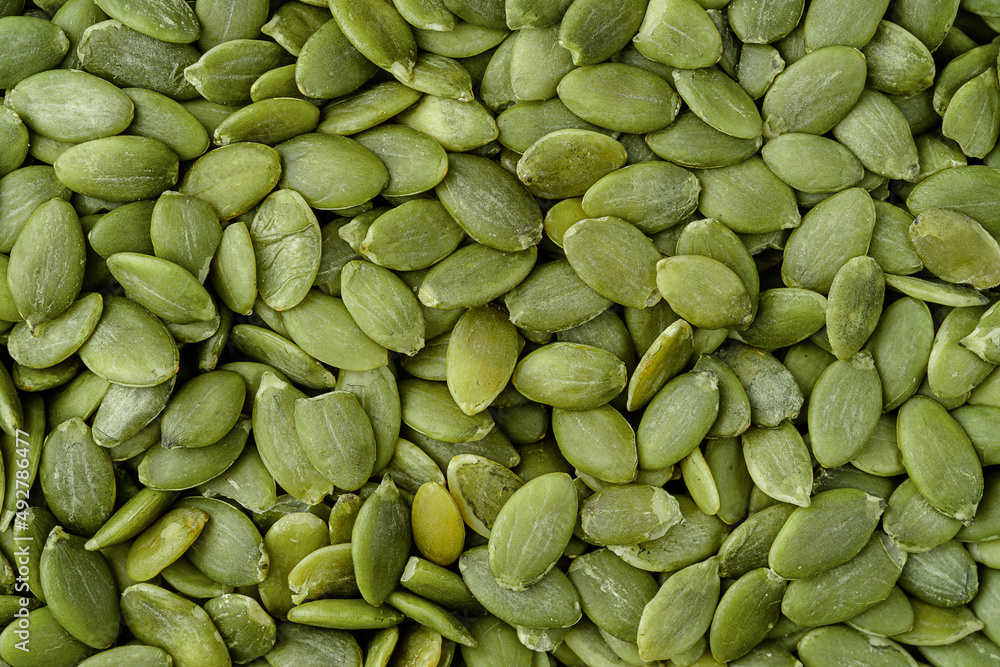 Green pumpkin seeds background. Top view Green pumpkin seeds background. Top view
