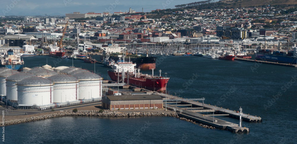 Cape Town, South Africa. 2022. Aerial view of oil storage tanks and tanker ship in the Port of Cape Town.ship in the port. Cape Town, South Africa. 2022. Aerial view of oil storage tanks and tanker ship in the Port of Cape Town.ship in the port.