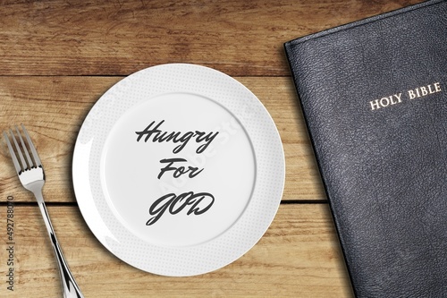 Fasting and prayer. Christian biblical concept, empty plate with Holy Bible.