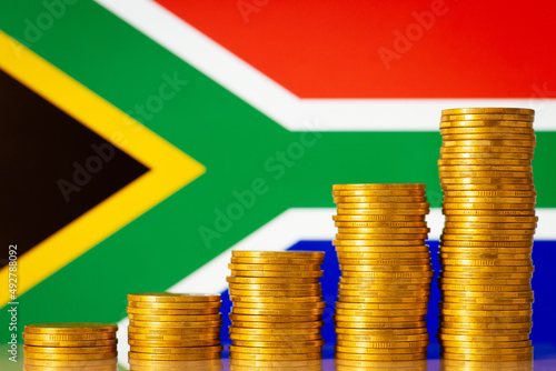 Concept of financial development of South Africa. Statistics of South Africa development, money stacks in front flag