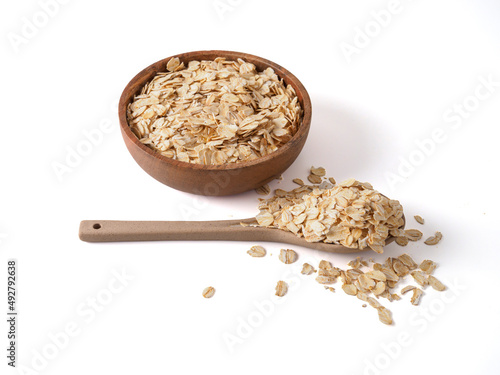 Gluten free wholegrain oat flakes in wooden bowl.