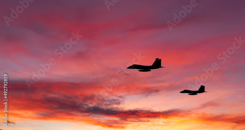 War aircrafts at sunset sky.