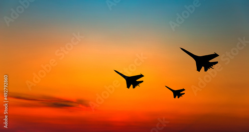 War aircrafts at sunset sky.