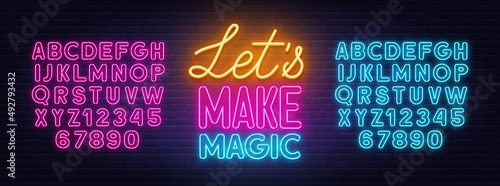 Let s Make Magic neon lettering on brick wall background.