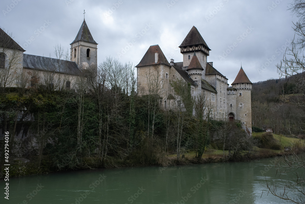 Scey-Maisieres, France - February 20 , 2022: The castle of Cleron is a 14th-century castle on the river Loue in the Bourgogne-Franche-Comte. Cloudy winter day. Selective focus.