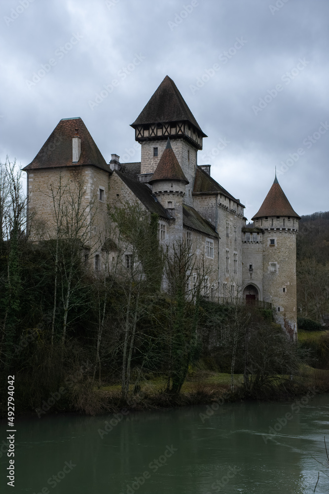 Scey-Maisieres, France - February 20 , 2022: The castle of Cleron is a 14th-century castle on the river Loue in the Bourgogne-Franche-Comte. Cloudy winter day. Selective focus.