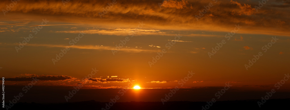 panoramic sunset with sun and clouds