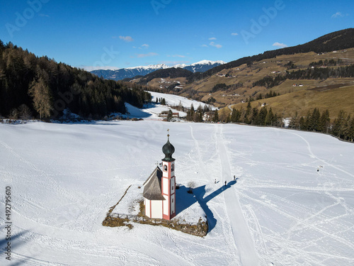 St. Magdalena or Santa Maddalena church in front of the Geisler or Odle dolomites mountain peaks in the Val di Funes in Italy in winter.