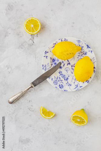 Retro plate with lemons on vintage white background and vintage knife