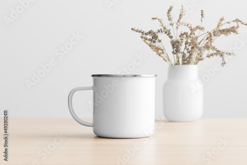 Enamel mug mockup with a lavender decoration on the wooden table.