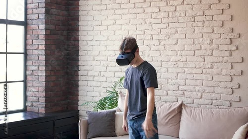 Wallpaper Mural A teenage boy with virtual reality glasses playing a game alone at home. Virtual cooking. Use of modern technology for entertainment and education. Torontodigital.ca