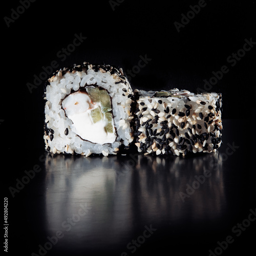 Cold cooked rice dressed with vinegar that is shaped into pieces and topped with raw or cooked fish, or formed into a roll with fish, egg, or vegetables and often wrapped in seaweed.