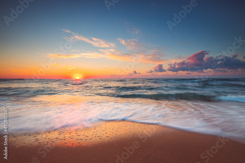 Tropical Beach sunrise over the sea shore and waves