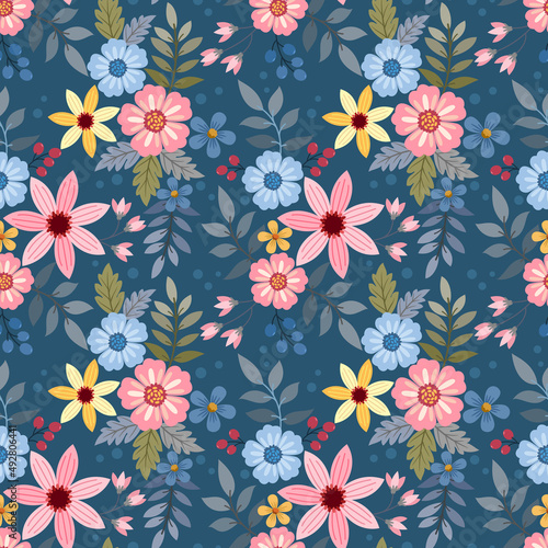 Colorful hand draw flowers on blue color background seamless pattern for fabric textile wallpaper.