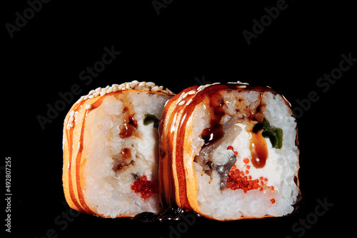 Cold cooked rice dressed with vinegar that is shaped into pieces and topped with raw or cooked fish, or formed into a roll with fish, egg, or vegetables and often wrapped in seaweed.