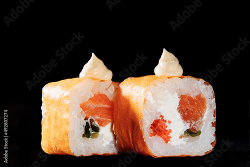 Cold cooked rice dressed with vinegar that is shaped into pieces and topped with raw or cooked fish, or formed into a roll with fish, egg, or vegetables and often wrapped in seaweed.