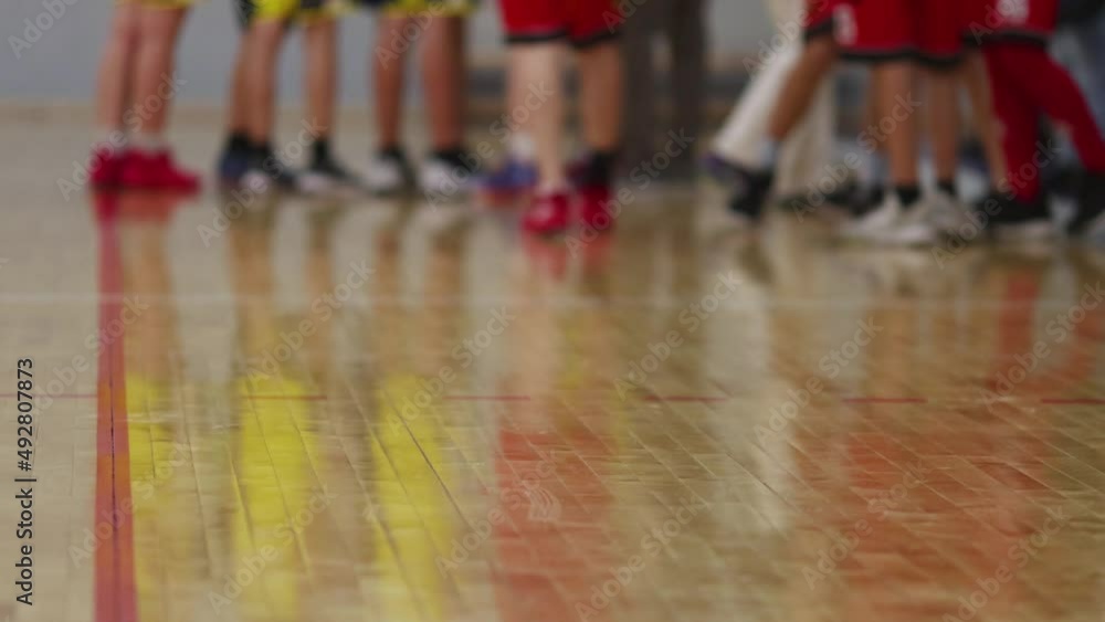 View of basketball court hall indoor venue with junior teenage school team playing in the background, basketball match game on arena stadium, team is blurred with copy space View of basketball court hall indoor venue with junior teenage school team playing in the background, basketball match game on arena stadium, team is blurred with copy space