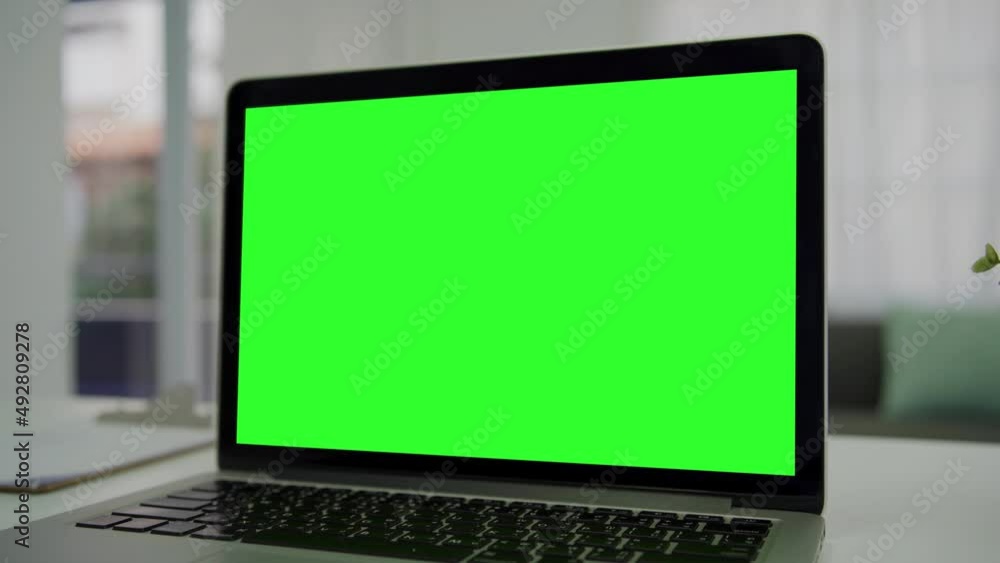 Green screen desktop set on table. Empty living room with modern chroma key green screen mock up computer set up for online videocall meeting. Pc with isolated display in home office Green screen desktop set on table. Empty living room with modern chroma key green screen mock up computer set up for online videocall meeting. Pc with isolated display in home office
