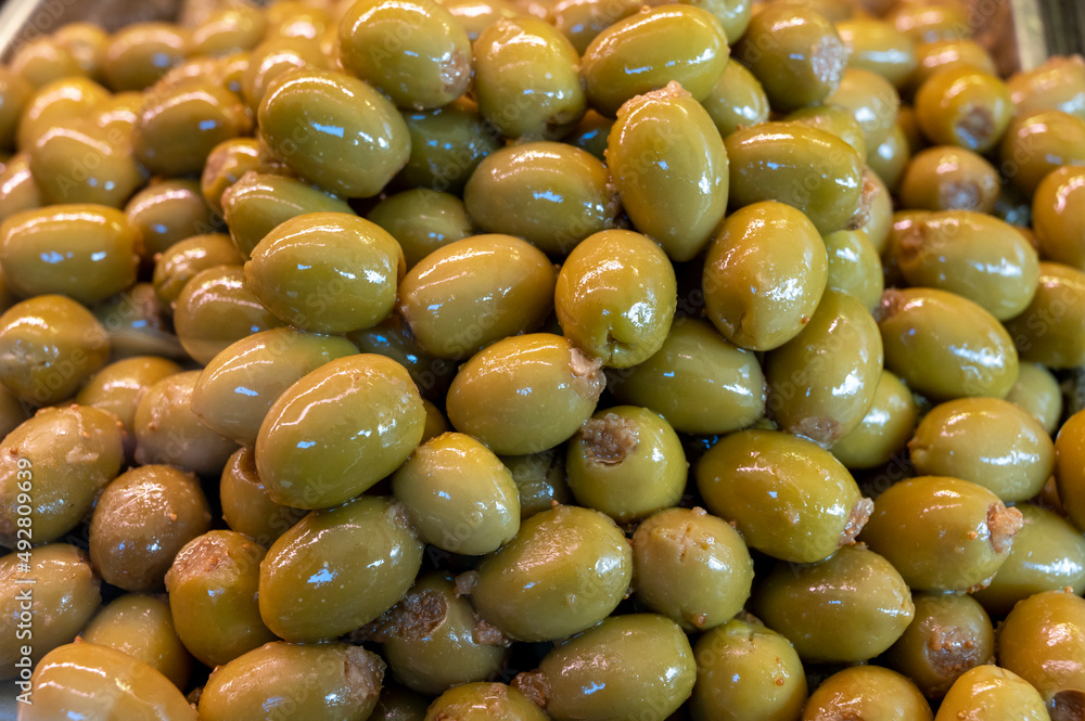 Green fresh olives close up on market, food background Green fresh olives close up on market, food background
