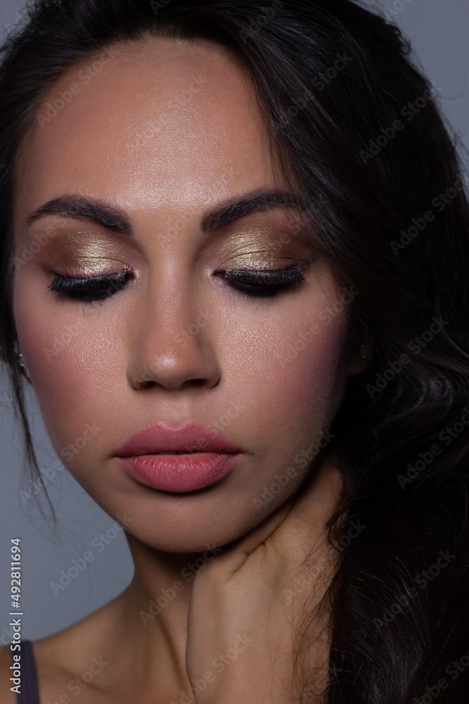 Beautiful brunet model woman face with brown eyes and perfect make-up . Portrait of beauty young brunet girl with pink lips. Female face with clear skin close-up. Skincare Beautiful brunet model woman face with brown eyes and perfect make-up . Portrait of beauty young brunet girl with pink lips. Female face with clear skin close-up. Skincare