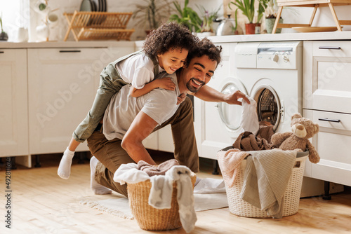Fotografie Father and son doing laundry together