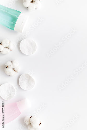 mycelial water, lotion and cotton pads for skin care on white background flat lay space for text
