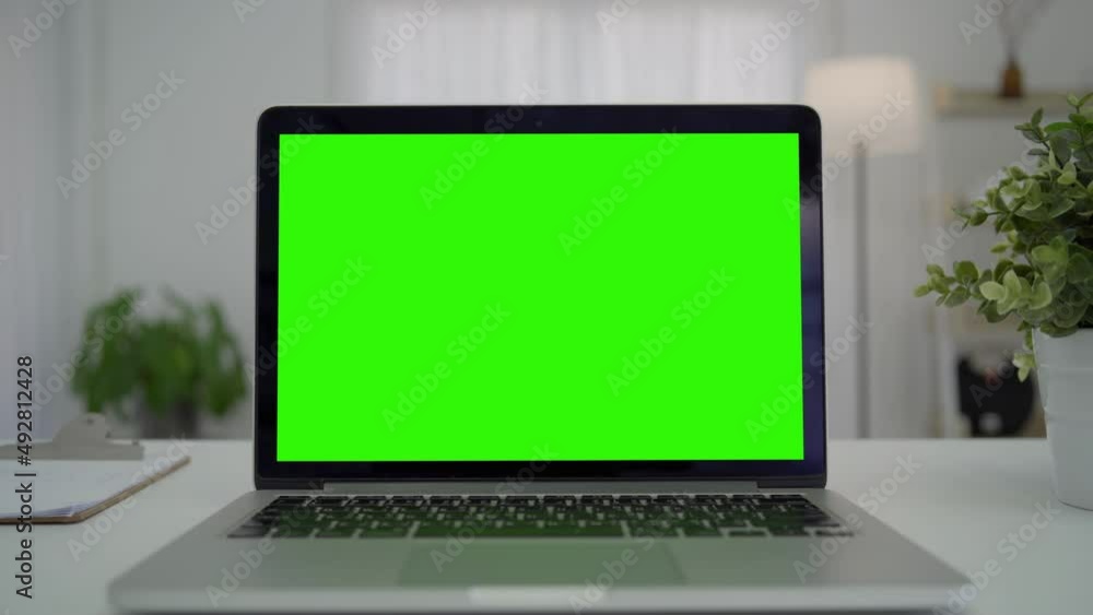 Green screen desktop set on table. Empty living room with modern chroma key green screen mock up computer set up for online videocall meeting. Pc with isolated display in home office Green screen desktop set on table. Empty living room with modern chroma key green screen mock up computer set up for online videocall meeting. Pc with isolated display in home office