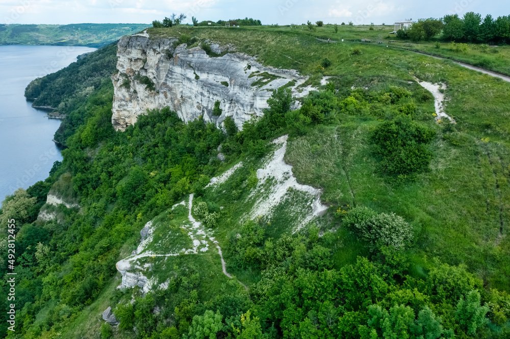Magnificent aerial view on small tributary of the Dniester River with picturesque shores. National Nature Park Podilski Tovtry, the Dniester River, Ukraine. Beautiful view from flying drone. Magnificent aerial view on small tributary of the Dniester River with picturesque shores. National Nature Park Podilski Tovtry, the Dniester River, Ukraine. Beautiful view from flying drone.