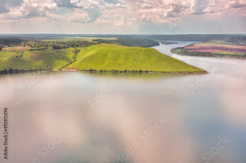 Magnificent aerial view on small tributary of the Dniester River with picturesque shores. National Nature Park Podilski Tovtry, the Dniester River, Ukraine. Beautiful view from flying drone. © Volodymyr