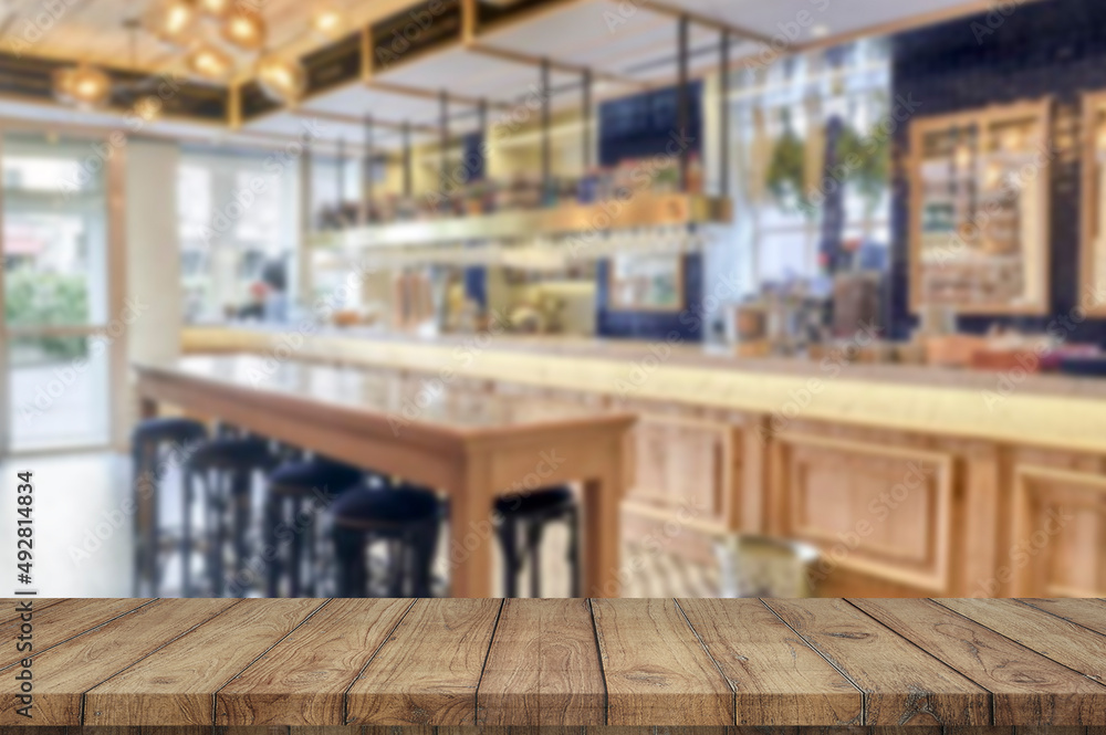 Wooden board empty table blurred restaurant background used for display products Wooden board empty table blurred restaurant background used for display products