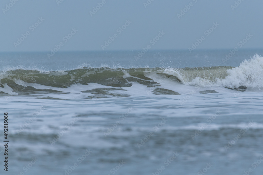 Rushing waves on the sandy beach of  Juist