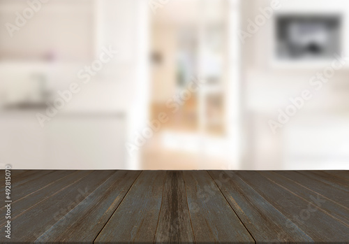 Wooden board empty table top on of blurred office background.