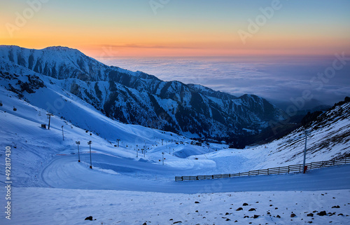 Shymbulak mountain resort snowy empty ski slope at sunset photo