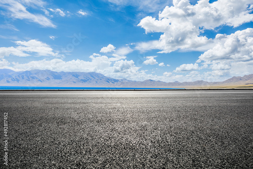 Asphalt road and lake with mountain natural landscape © ABCDstock