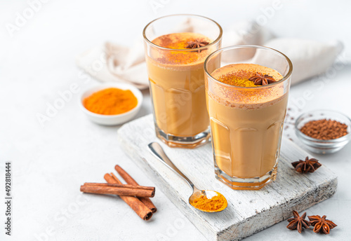 Latte with turmeric and cinnamon on a white background.