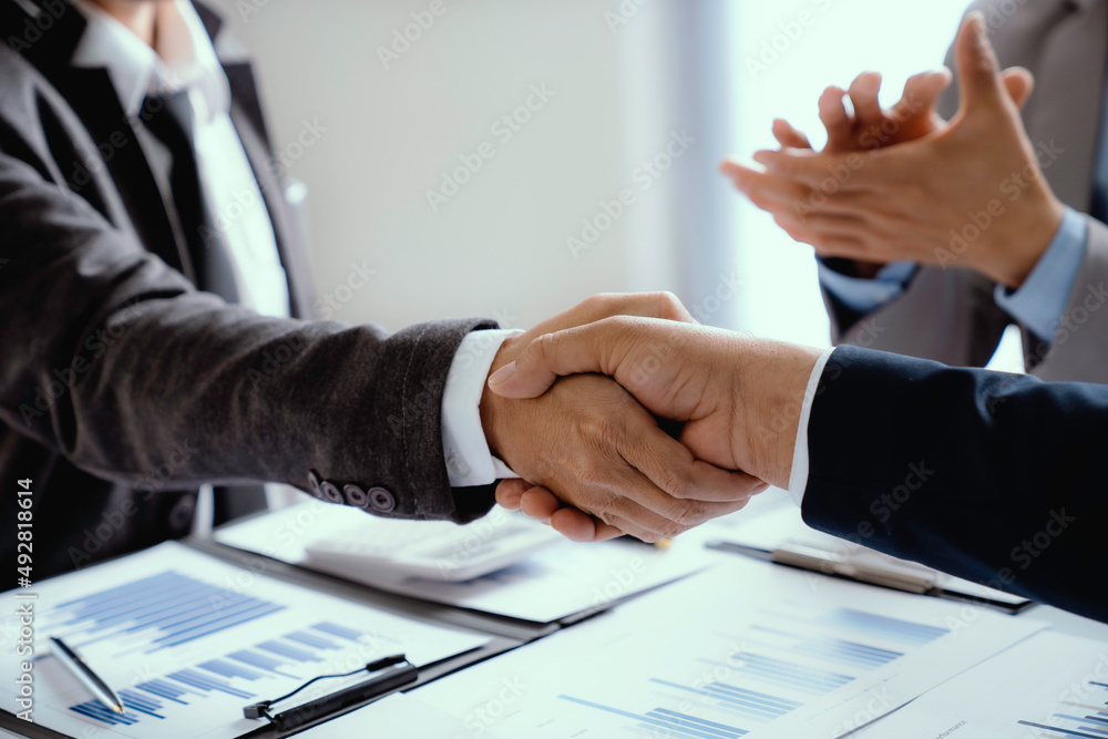 Business people shaking hands, finishing up meeting,  business handshake for successful of investment deal, teamwork and partnership concept.