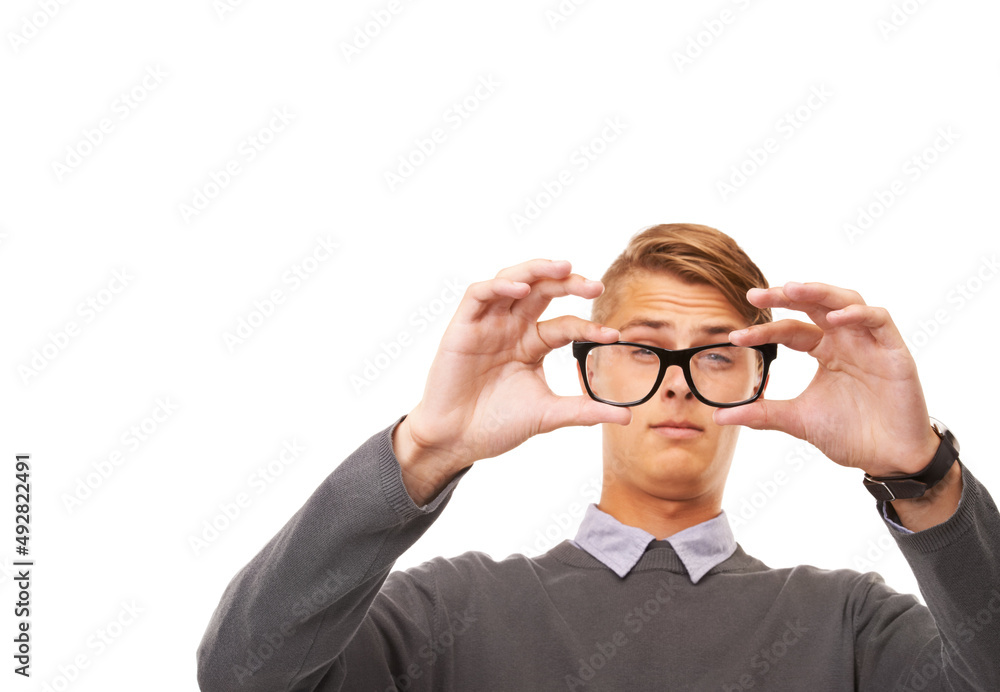 Time for some new glasses. Studio shot of a young man squinting through a pair of glasses while isolated on white.