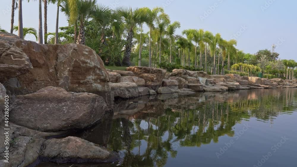 Stone shore of the city pond during the day.