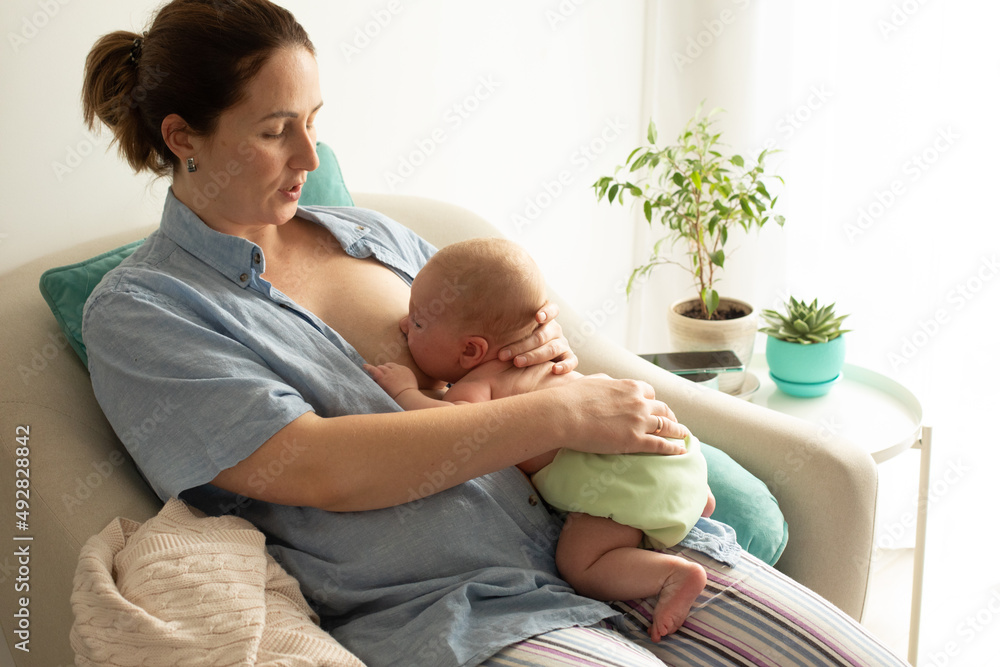 Mothed and baby, breastfeeding in laid back position foto de Stock | Adobe  Stock