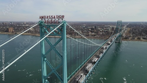 Ambassador bridge logo with endless line of trucks crossing USA - Canada border. Aerial view photo