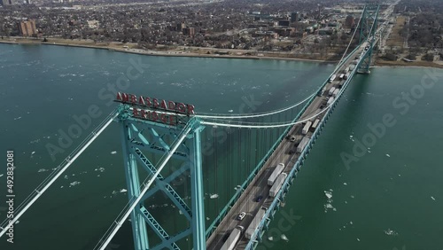 Ambassador bridge over Detroit river with long line of semi-trucks passing USA - Canada border. Aerial view photo