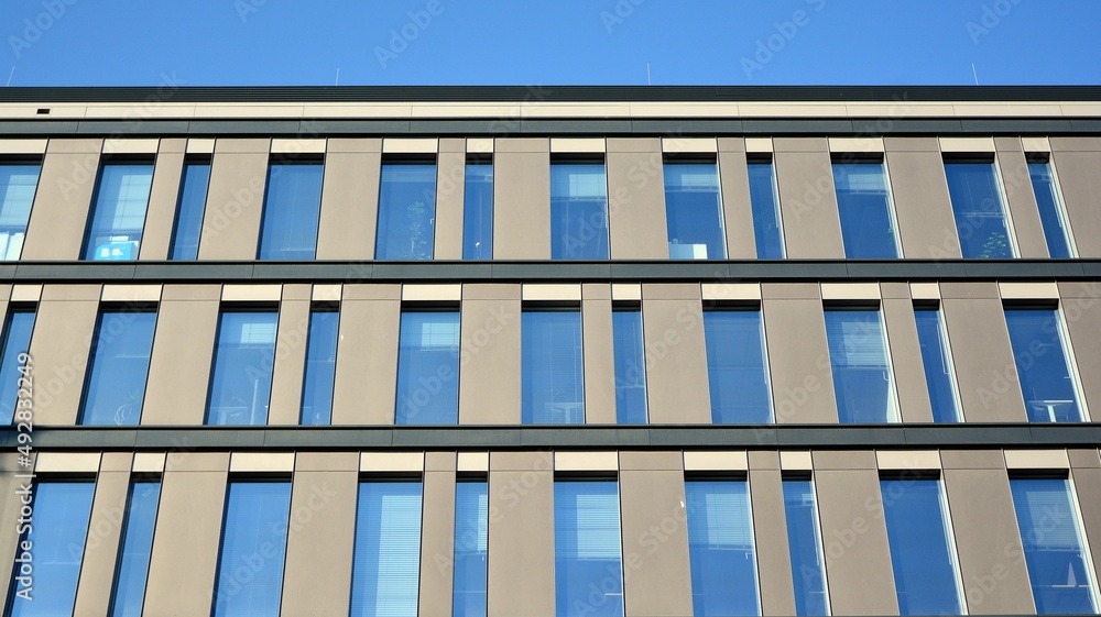 Modern office building in the city with windows and steel and aluminum panels wall. Modern office building in the city with windows and steel and aluminum panels wall.