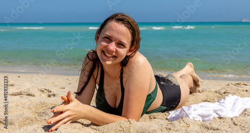 Beautiful woman relaxes at the beach of Miami on a sunny day - South Beach - travel photography