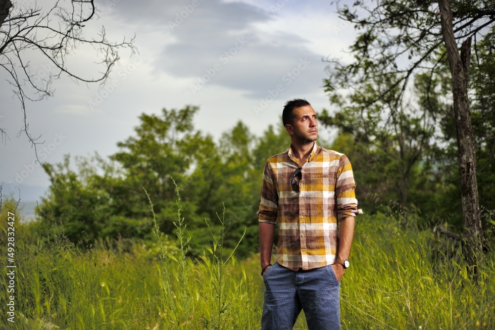 man in shirt with strips pictured in nature