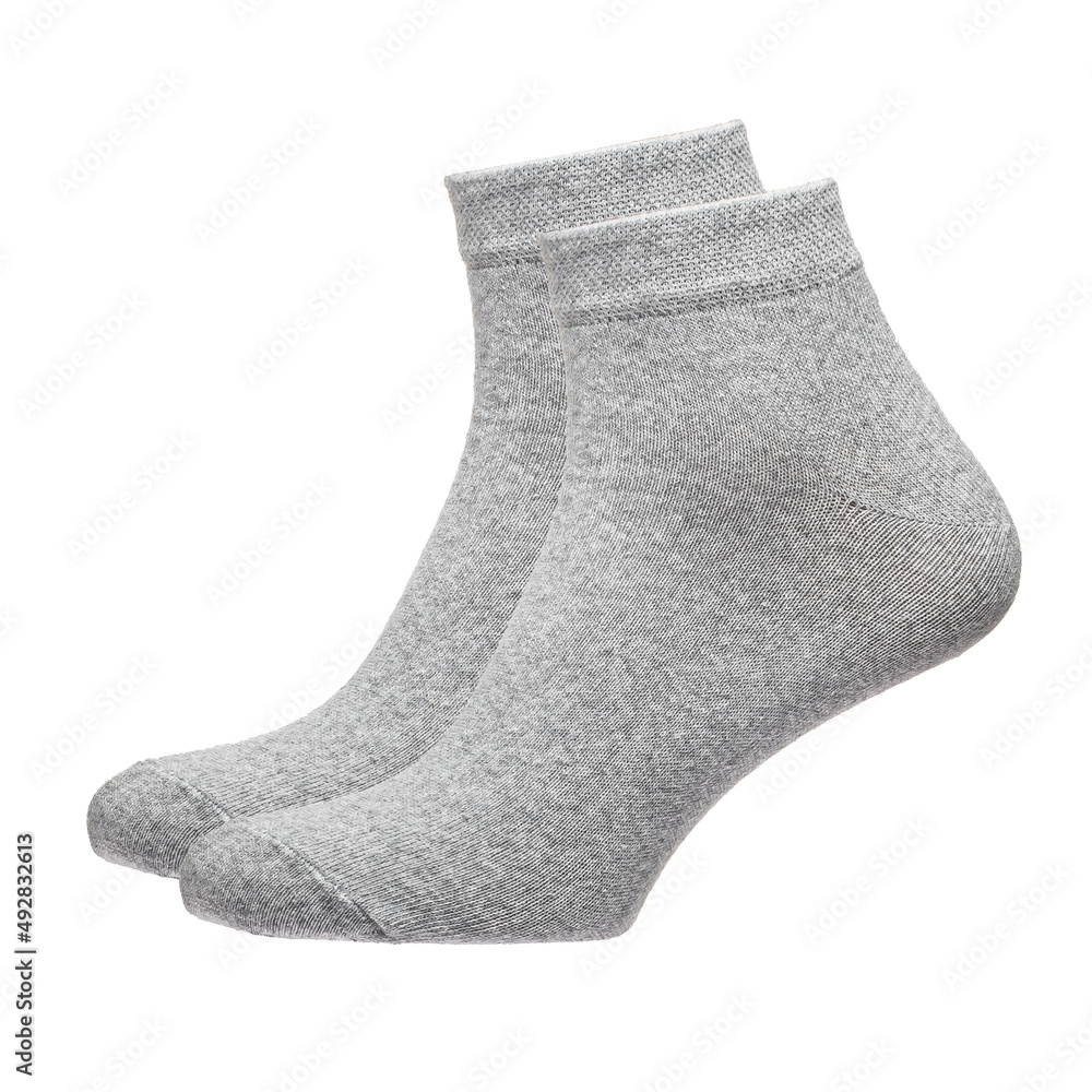 A pair of fabric socks stands on a white isolated background. Volumetric socks on a transparent mannequin. Gray socks. A pair of fabric socks stands on a white isolated background. Volumetric socks on a transparent mannequin. Gray socks.
