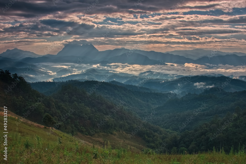 Light beam over a mountain valley with twilight sky in a morning Light beam over a mountain valley with twilight sky in a morning